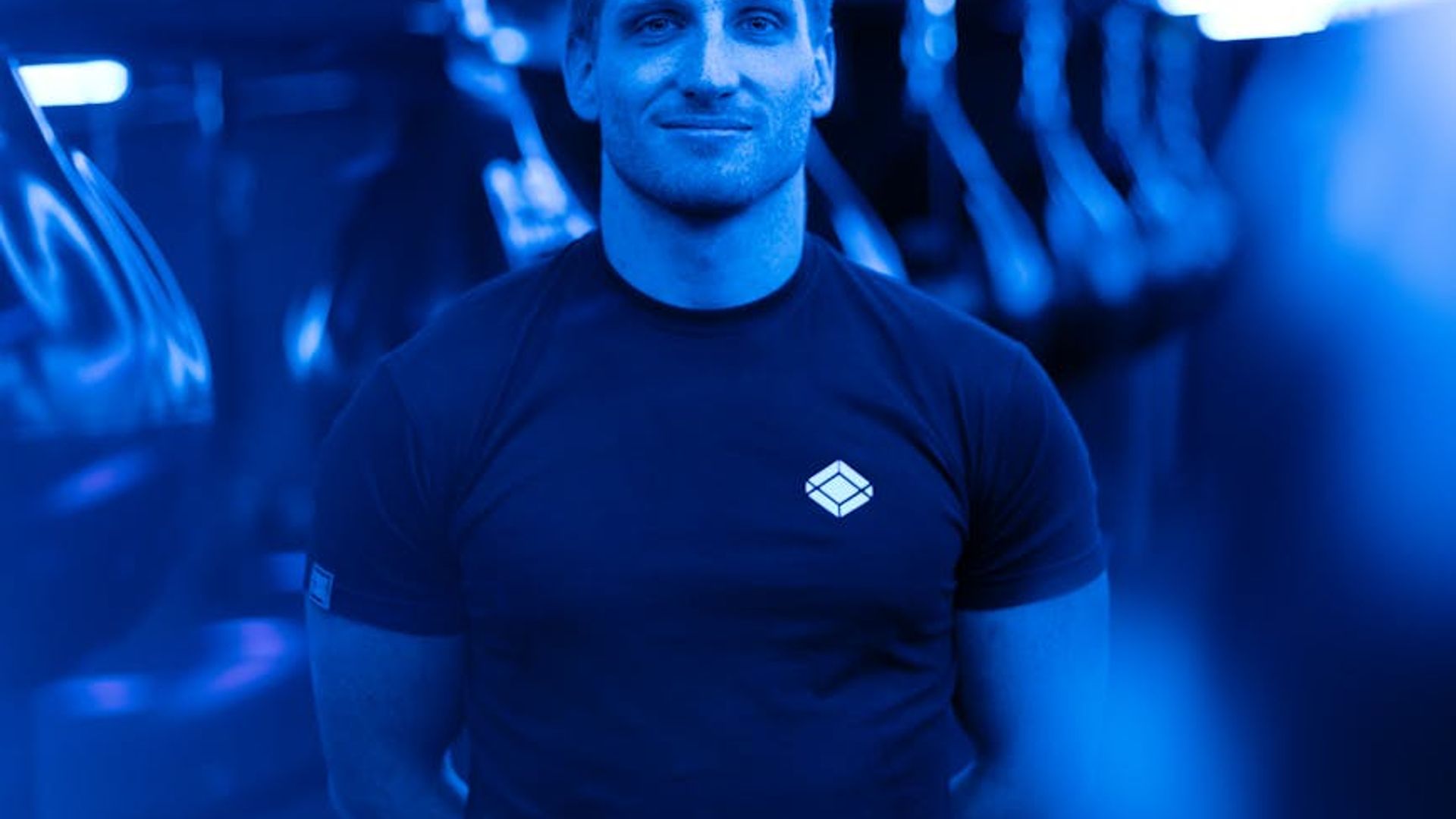 Atmospheric dark fitness studio with subtle neon rose lighting