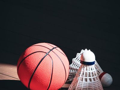 Close up of sports equipment on a dark wooden floor