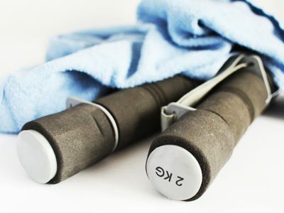 Glass of water and a towel in a gym setting