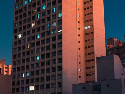 Silhouette of woman stretching near a large window